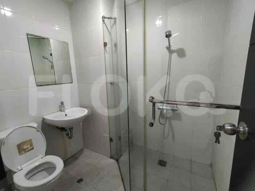 Bathroom with a toilet, sink, and shower.