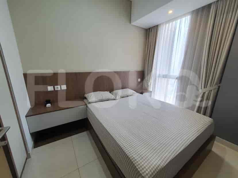 Bedroom with a queen-sized bed, bedside tables, and a large window with curtains.