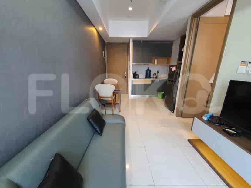Living area with a sofa and a kitchenette.