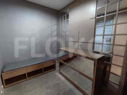 Room with wooden storage units and mirror.