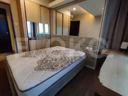 A bedroom with a bed, mirror, and closet.