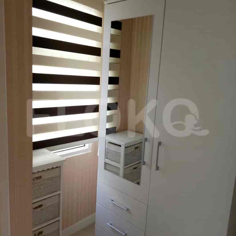 A view of a closet with a mirror, drawers, and blinds.