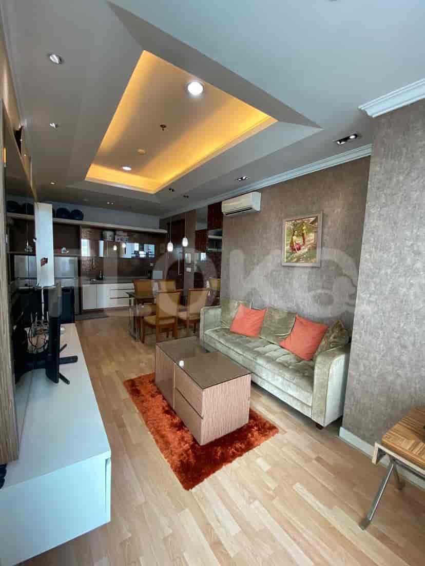 Living room featuring a sofa, coffee table, and entertainment center.