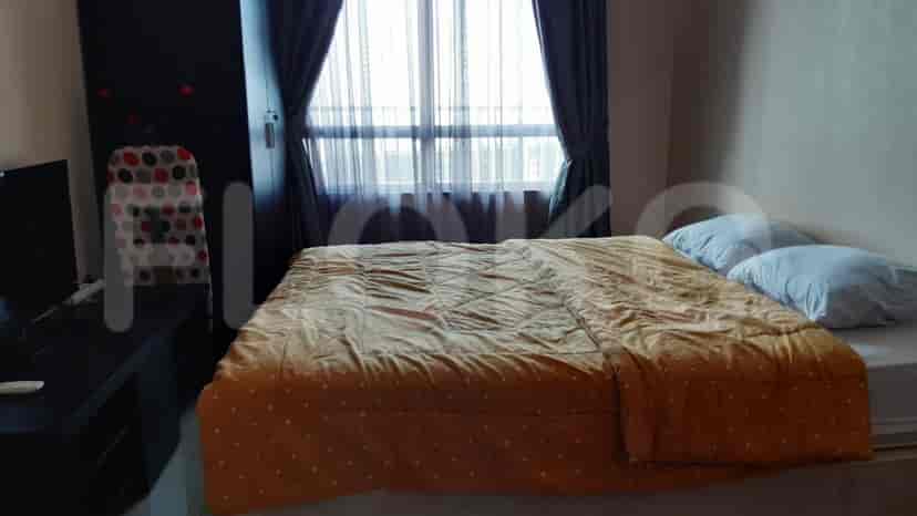 Bedroom with a double bed, wardrobe, and sheer curtains.