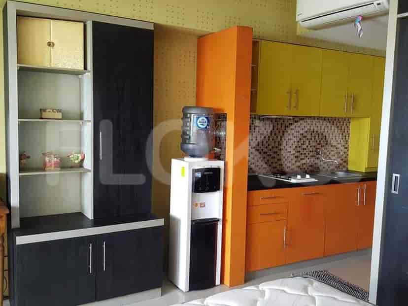 A living space featuring kitchen elements and storage solutions.