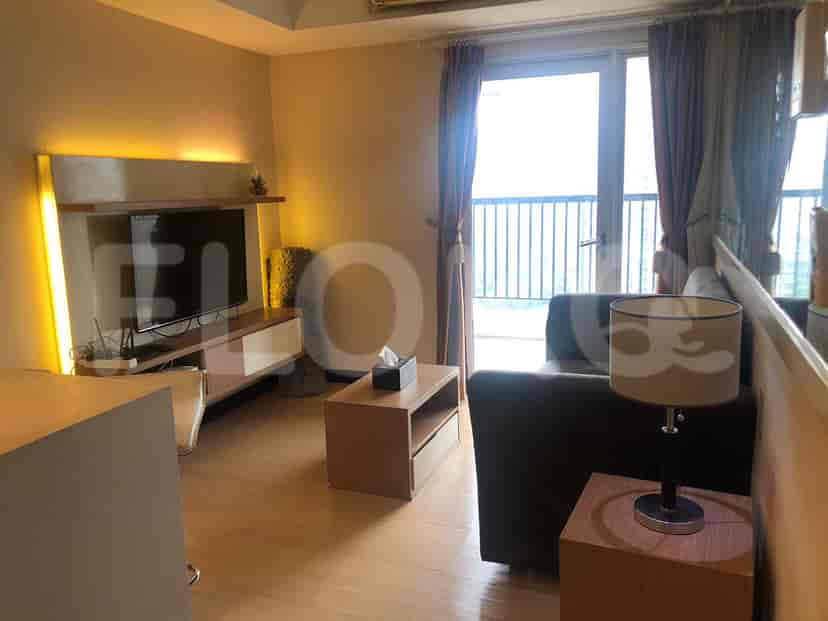 Living room with TV and balcony access.