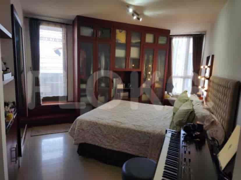 A bedroom with a bed and large wardrobe.