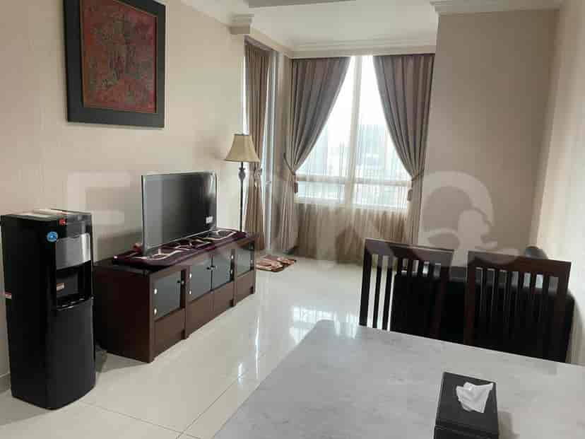 Living area with TV, water dispenser, and window.
