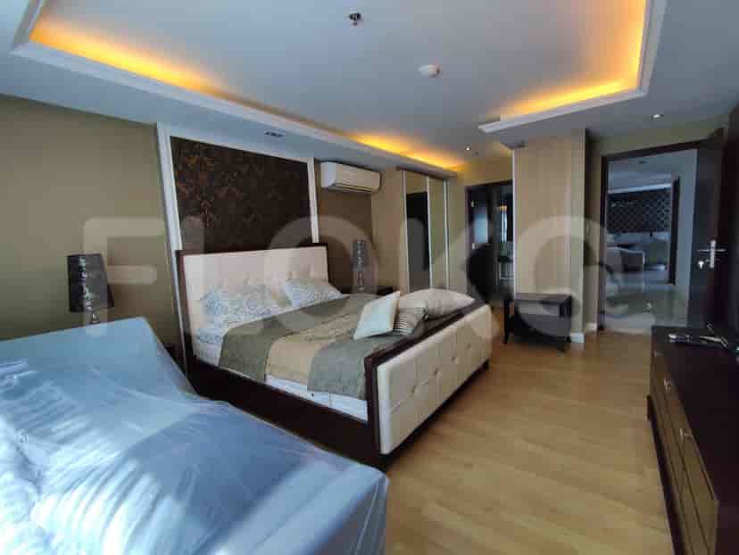 Master bedroom with large bed, air conditioning, and built-in wardrobe.