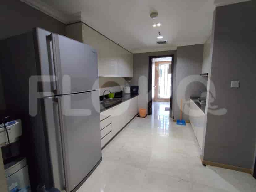 Modern kitchen with stainless steel appliances and white cabinetry.