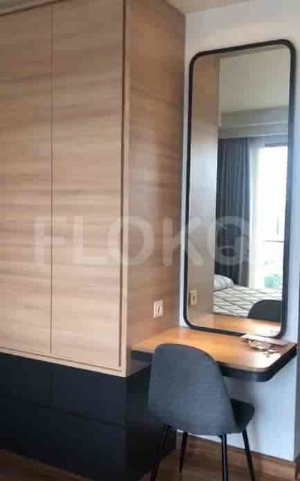 A well-organized dressing area with a mirror and desk.