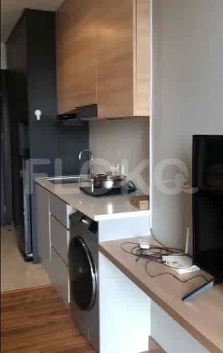 A compact kitchen with appliances and wooden cabinets.