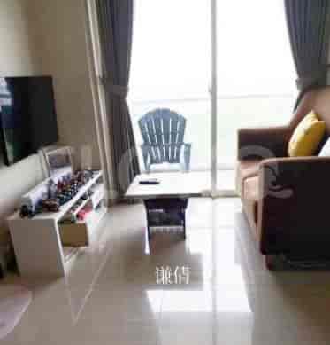 Bright living room with a TV, white cabinet, table, and brown sofa.