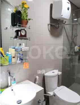 Bathroom with a mirror, sink, and toilet.
