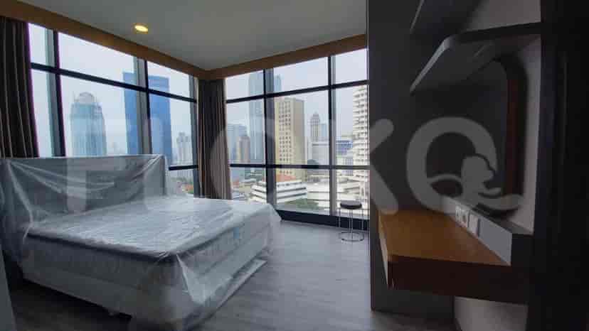 Another bedroom with a bed, desk and a city view.