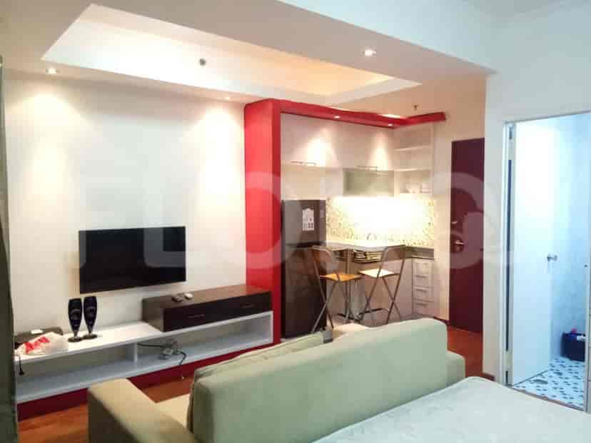 Studio apartment showing the living area, kitchenette, and smart TV.