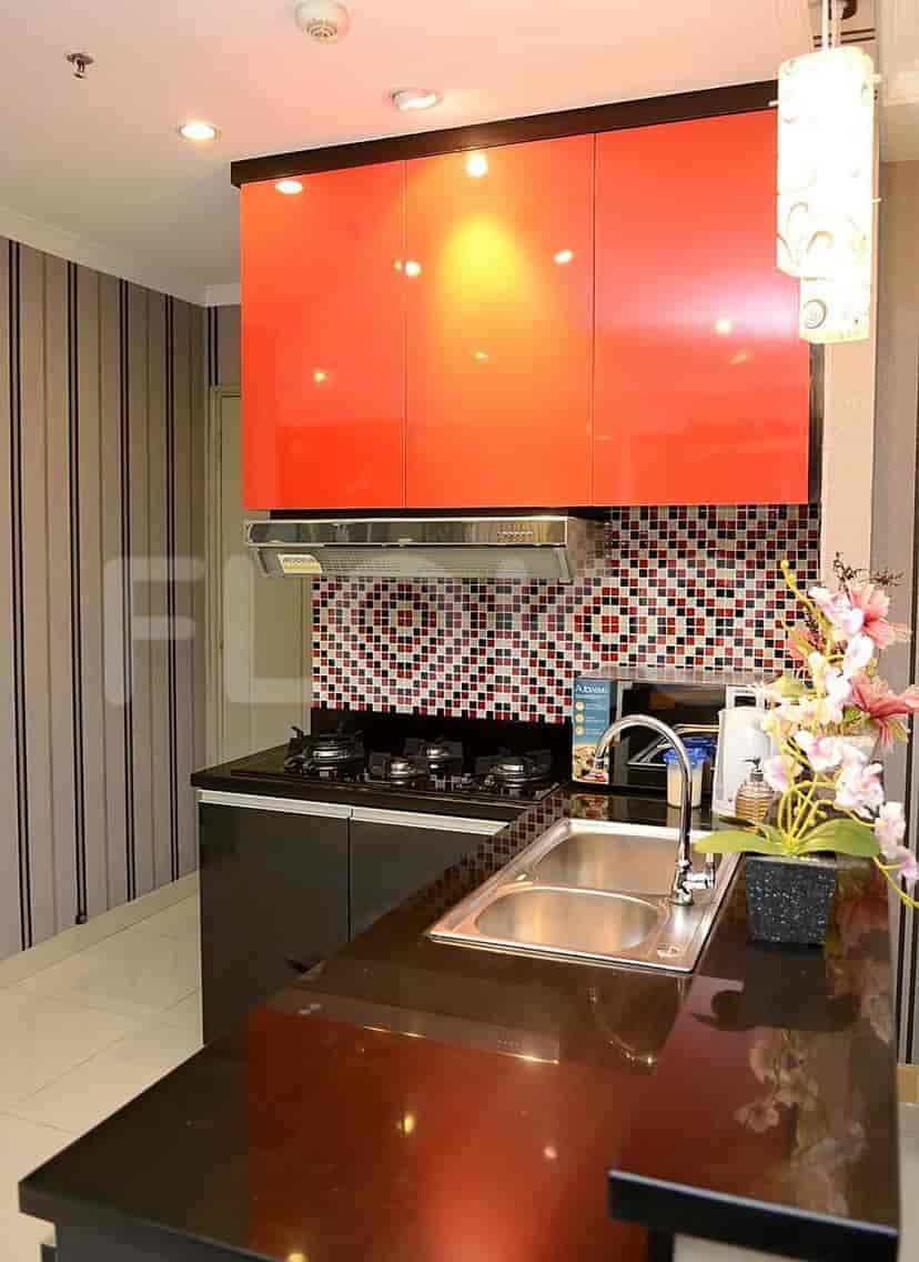 Close up of kitchen with stove and sink.