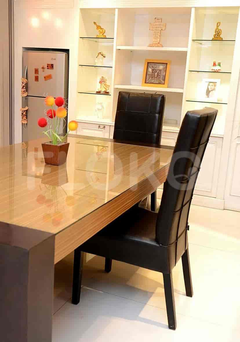 Dining area with table and chairs next to the kitchen.