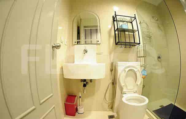 Bathroom with toilet, sink, and shower.