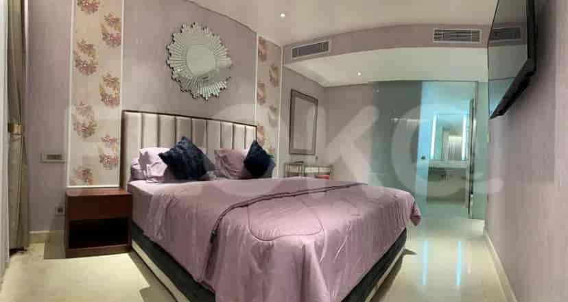 Another view of the bedroom, showing the queen bed, and a large mirror.