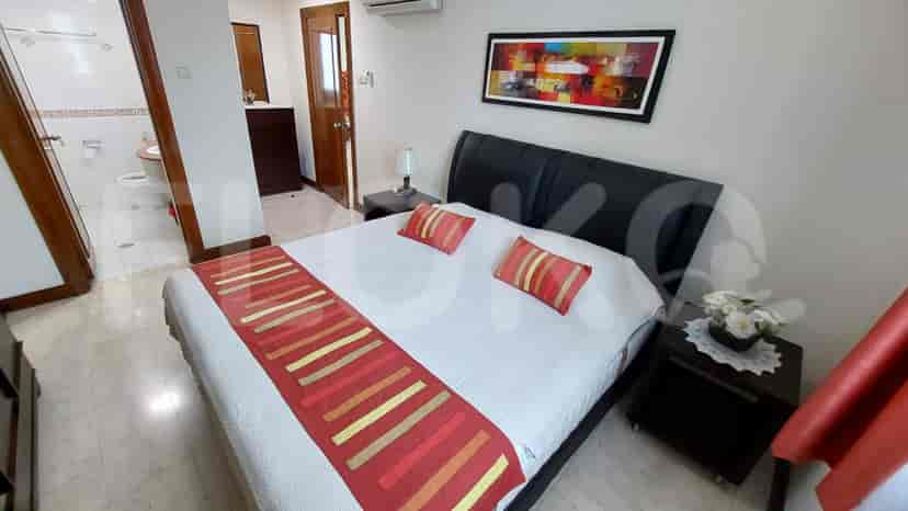 A bedroom with a queen bed and an ensuite bathroom.