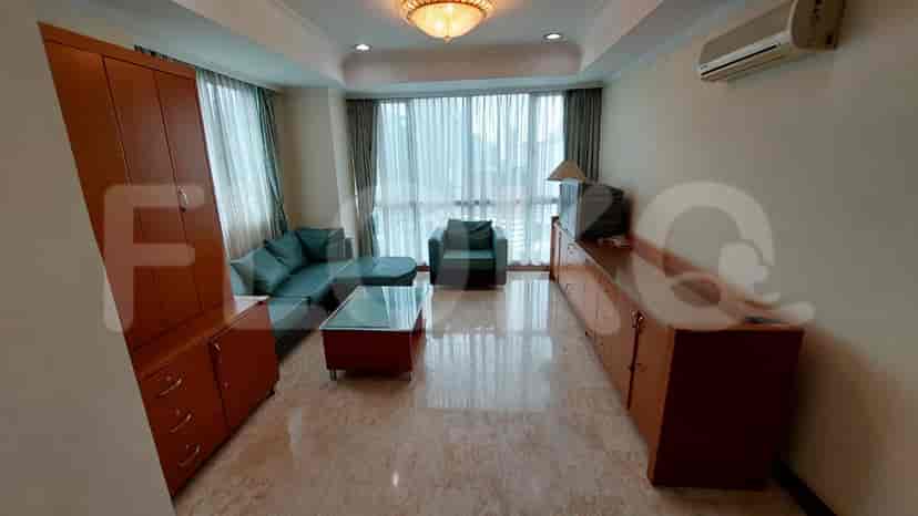Living room with sofa, tv and glass coffee table.
