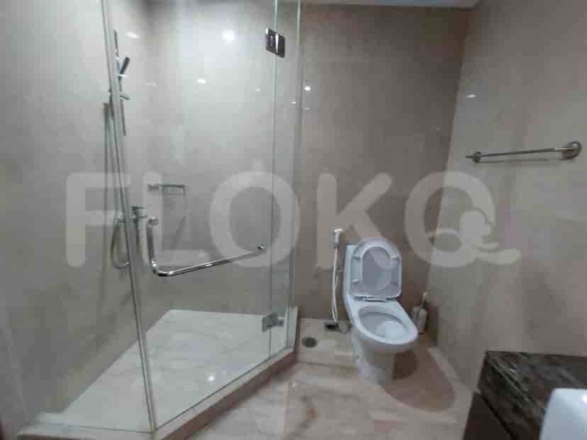 A modern bathroom with a walk-in shower, a toilet, and a sink.