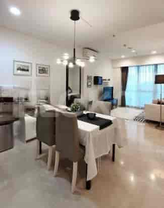 An open-concept living and dining area with modern furnishings, a sofa, and a dining table.