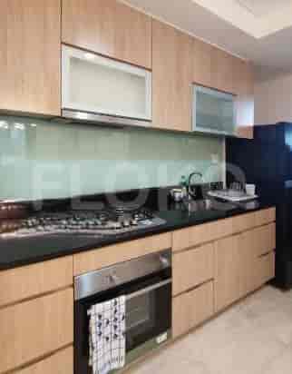 A modern kitchen with wooden cabinets, a stove, and a sink.