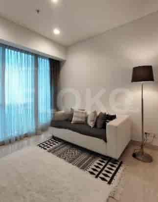 A modern living room with a sofa, curtains, and a rug.