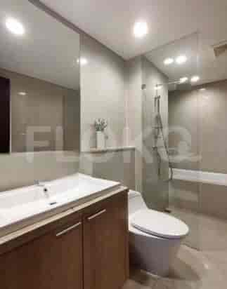 A modern bathroom with a bathtub, shower, and a vanity.