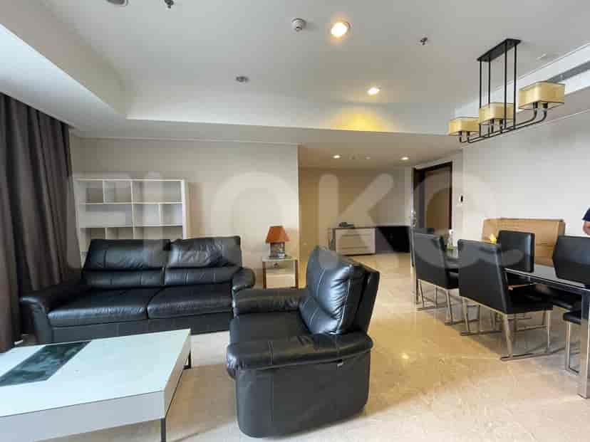 Living room and dining area with black furniture, a dining table, and a stylish chandelier.
