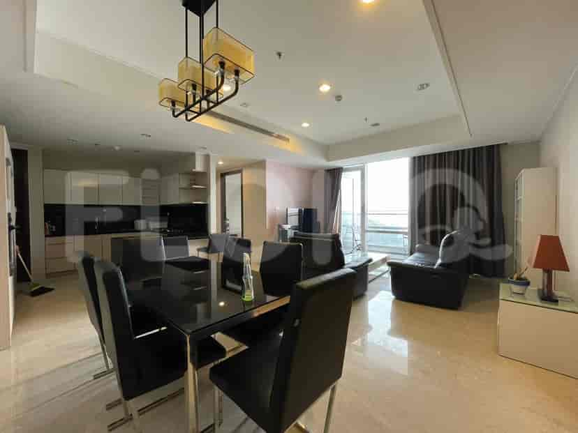 Modern kitchen with wooden cabinets, stainless steel appliances, and a black countertop.