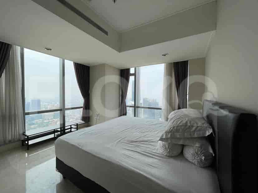 Bedroom with a single bed, a desk, and a TV, potentially used as an office space.