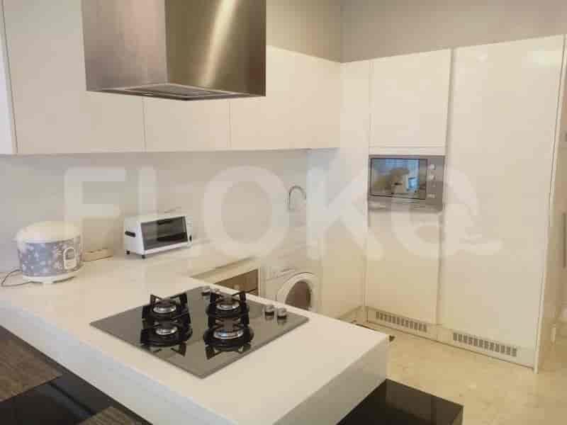 Kitchen with appliances, including a stove, microwave, and washer/dryer.