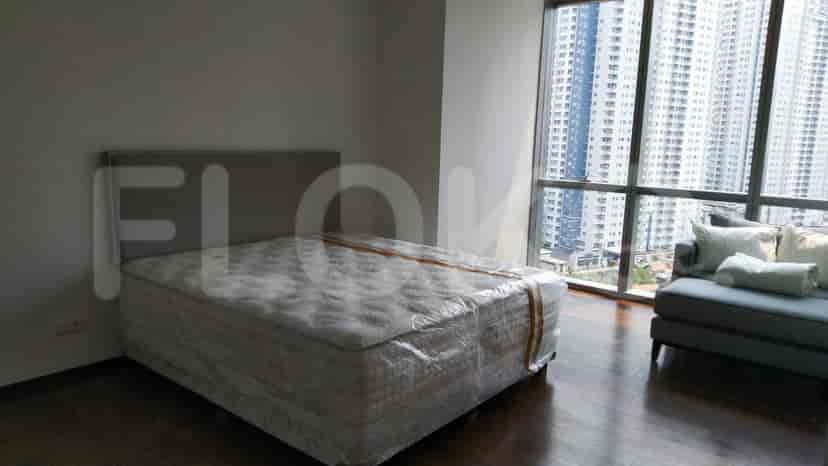 Bedroom featuring a bed with a gray headboard and a city view.