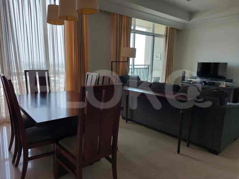 Dining area with adjoining living space and a view to the balcony.