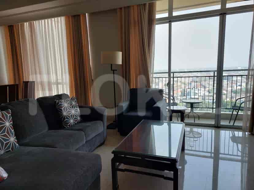 Living room with balcony access and city view.