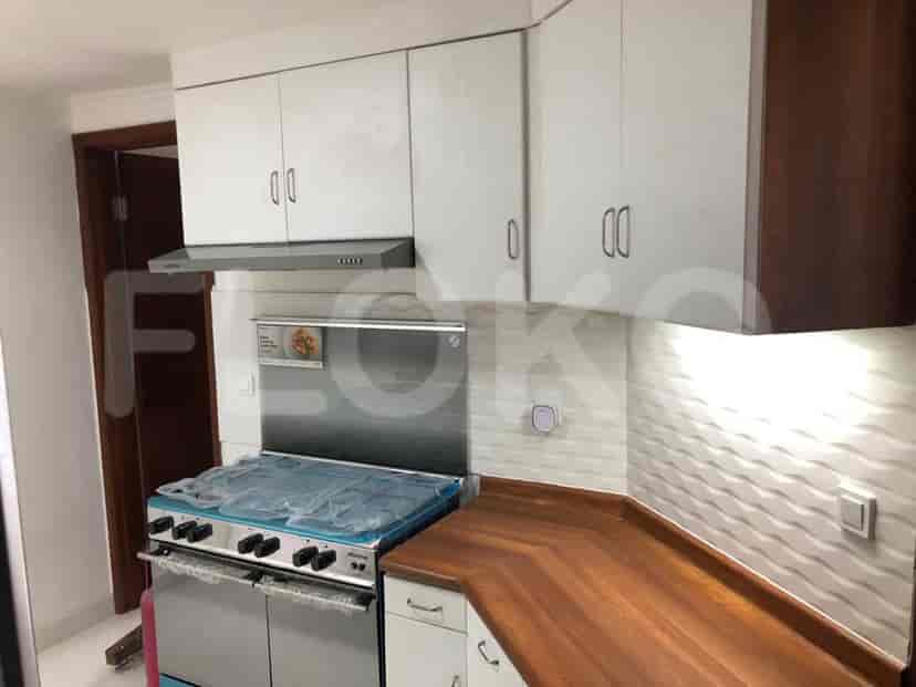 Modern kitchen with white cabinets, a gas stove, and wooden countertops.