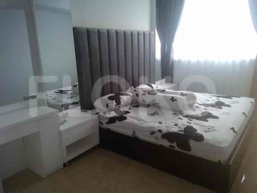 Bedroom with bed and dresser.