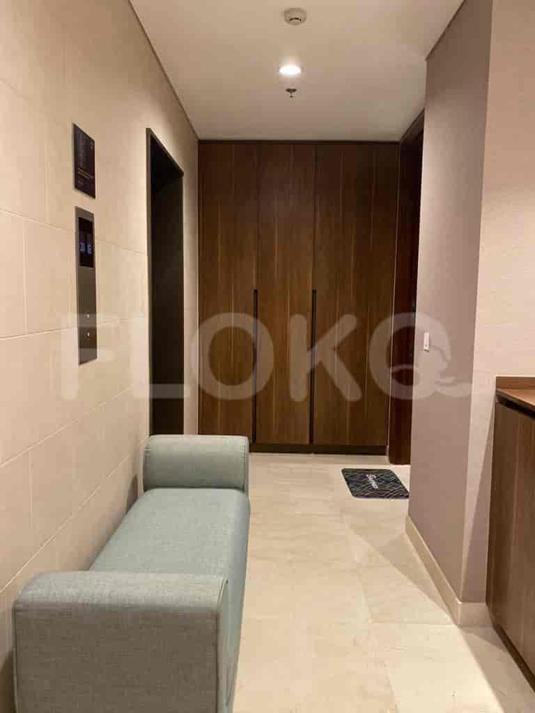 Hallway featuring a built-in wardrobe and a bench.