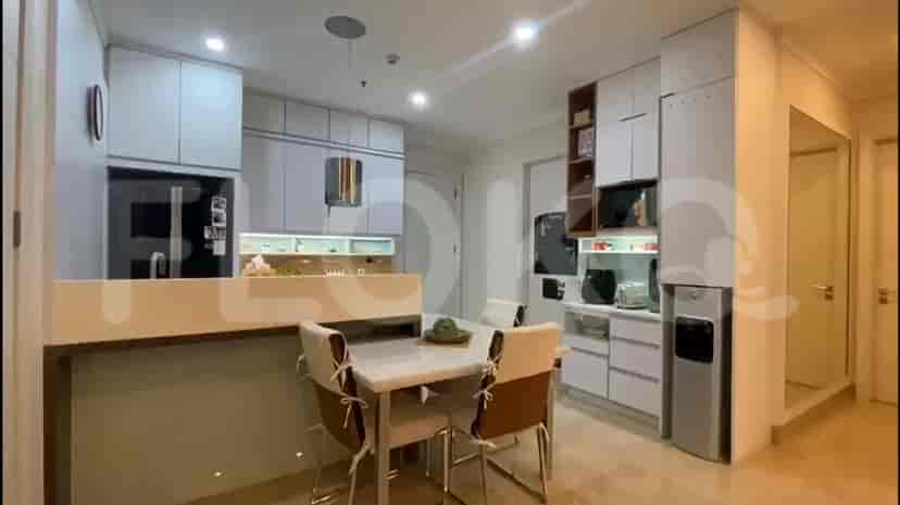 Modern open-concept kitchen with light-colored cabinets and a dining area.