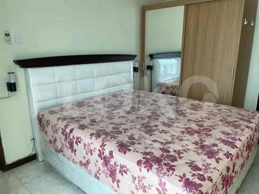 Bedroom featuring a large bed with floral bedding and a mirrored closet.