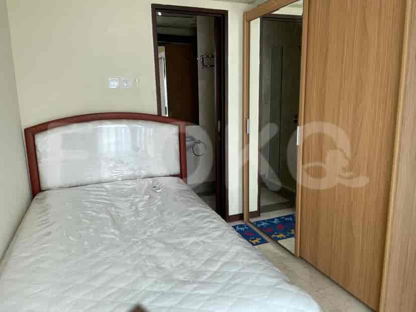 Bedroom with a bed, mirror, and access to a bathroom.