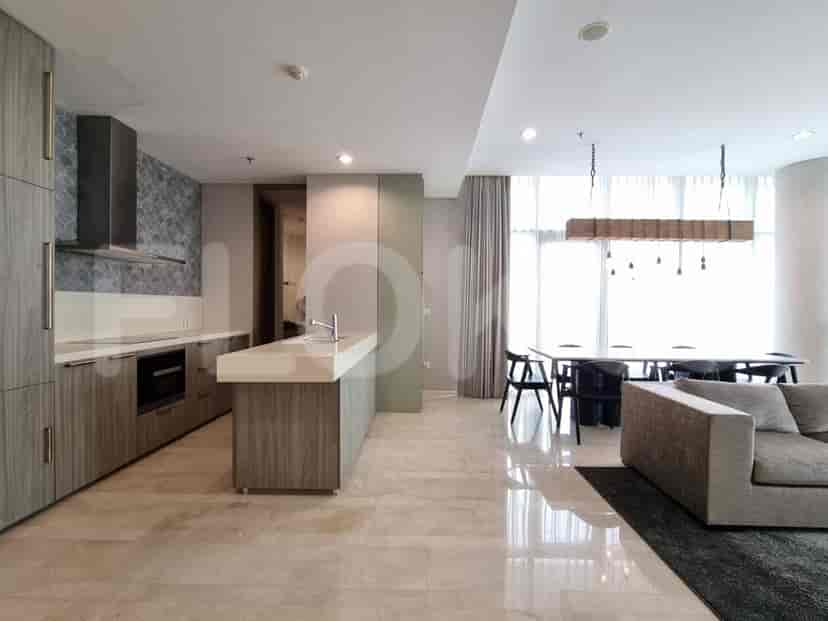A view of the kitchen and living room, showcasing an island and stylish design.