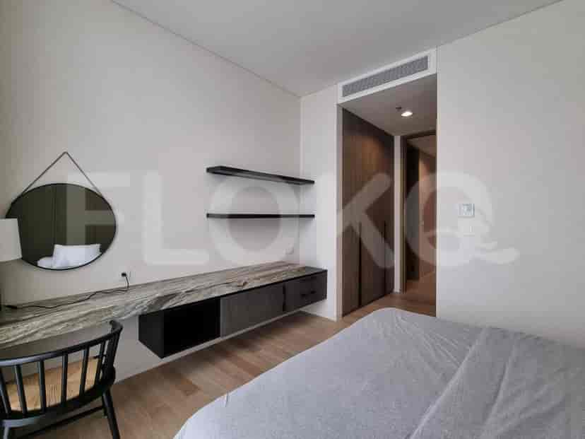 Bedroom with a vanity or desk area, neutral tones, and functional storage.