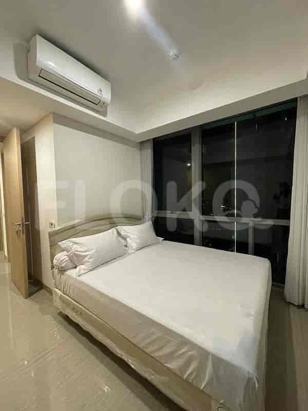 A bedroom with a bed, large window, and air conditioning.