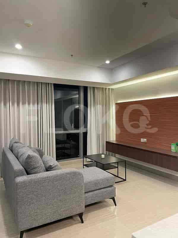A modern living room with a grey L-shaped sofa, a wooden media unit, and a large window.