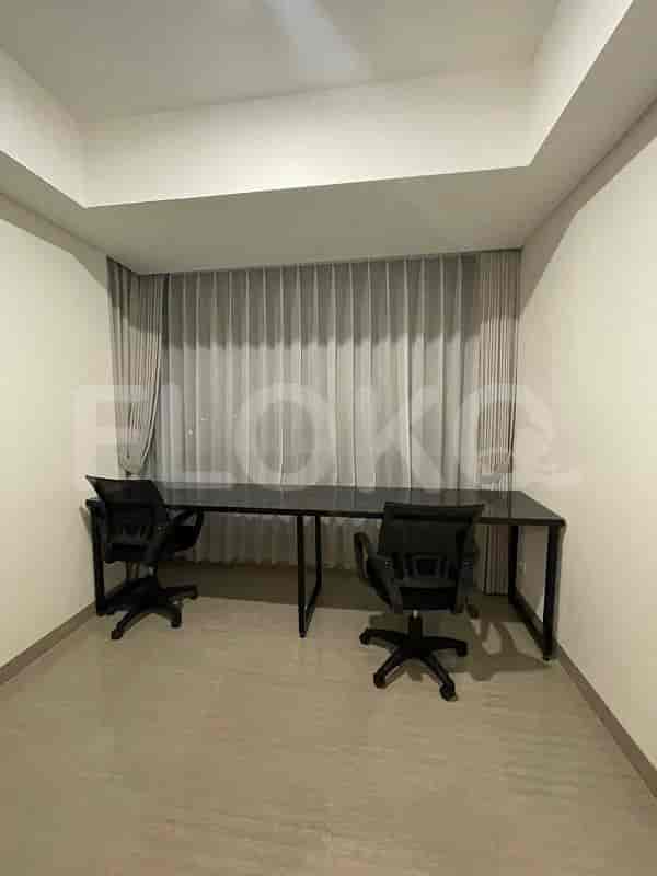 A dedicated workspace featuring a long desk and two office chairs.
