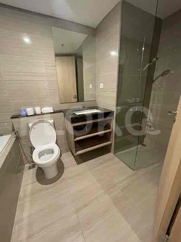A spacious bathroom with a bathtub, sink, and toilet.